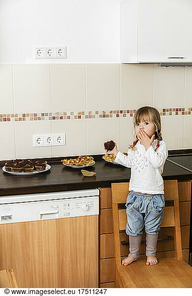Girl eating baked muffins