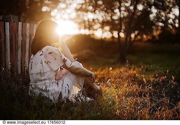 Girl enjoy summer sunset in backlit