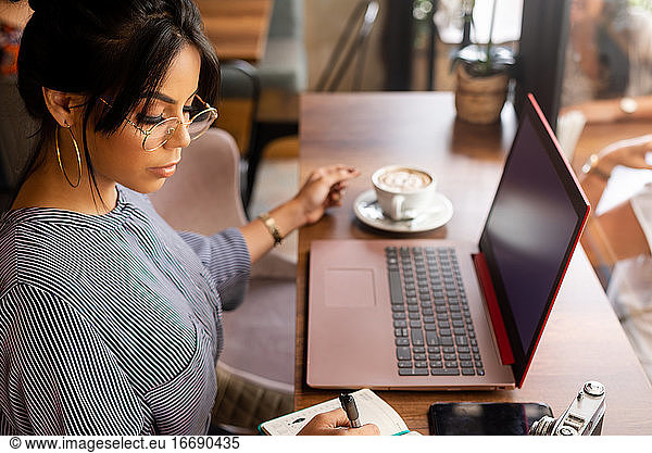 girl having a coffee while working in a cozy environment