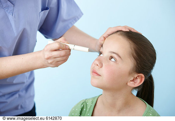 Girl having eye test