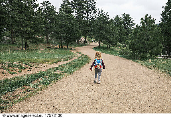 Girl hiking with a backpack at Mount Falcon Park