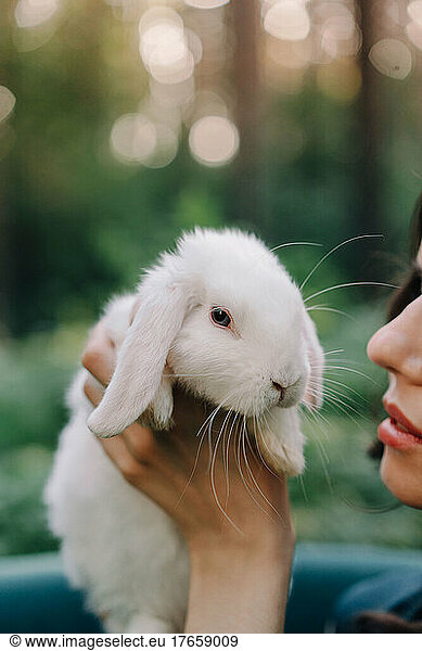 Girl holding a white rabbit