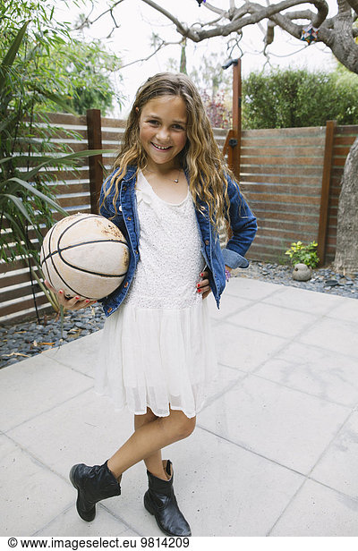 Girl holding basketball  portrait