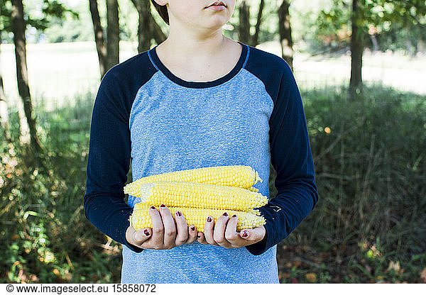 Girl Holding Fresh Sweet Corn