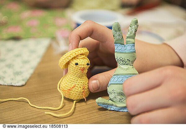 Girl holding handmade chick and rabbit