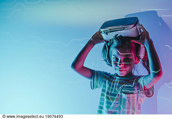 Girl holding virtual reality simulator over head