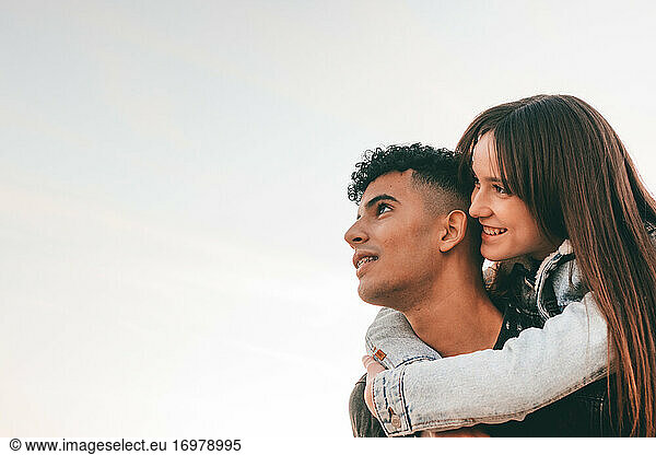 Girl Hugged On The Back Of Her Boyfriend Looking At The Sky