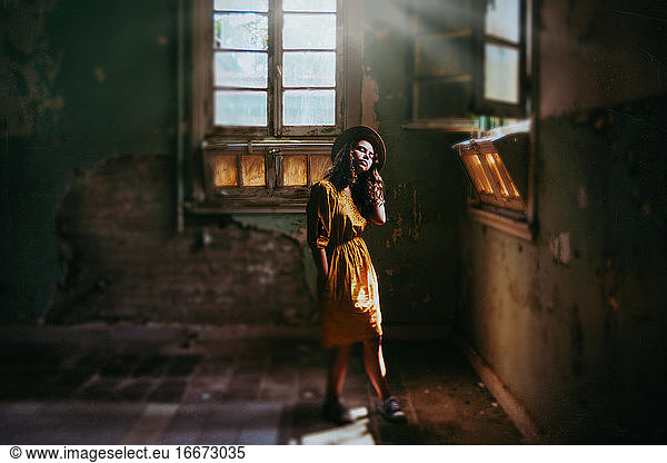 girl in derelict building with beautiful light