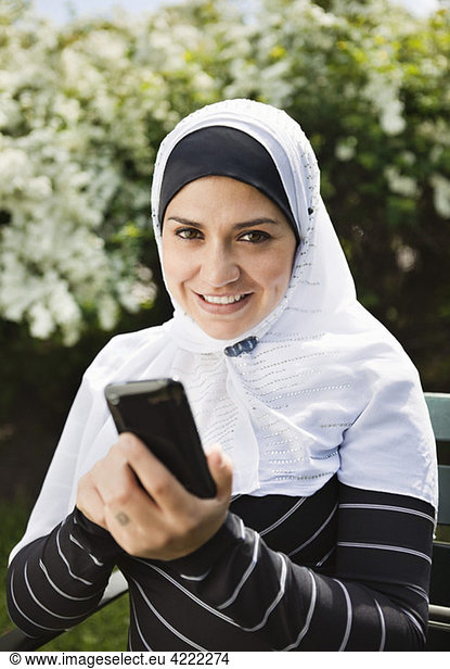 Girl in head scarf with mobile