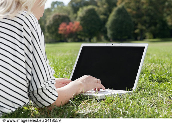 Girl in park with computer