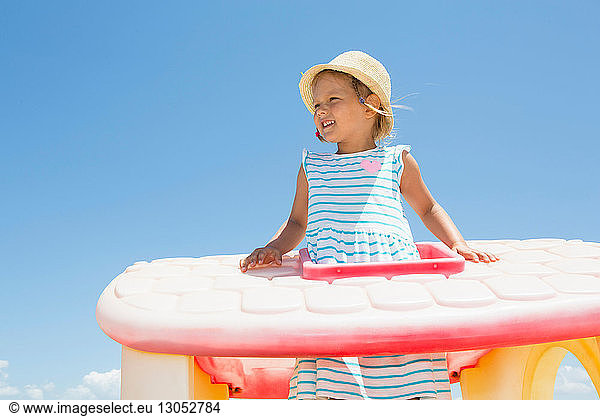 Girl in sun hat looking out from plastic roof on beach  Castellammare del Golfo  Sicily  Italy