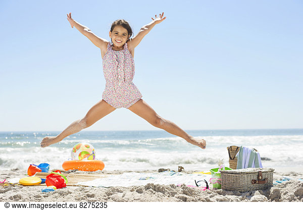 Girl jumping on beach
