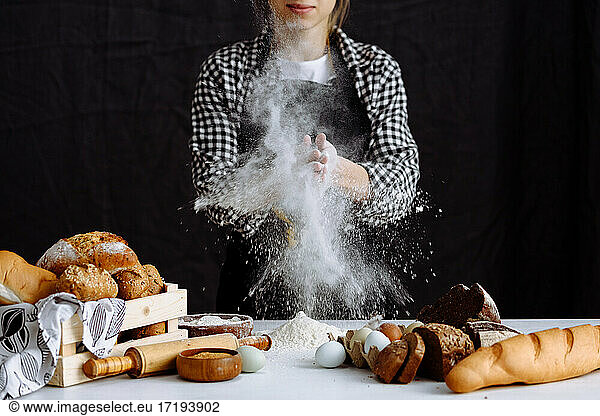 girl makes bread dough in a kitchen