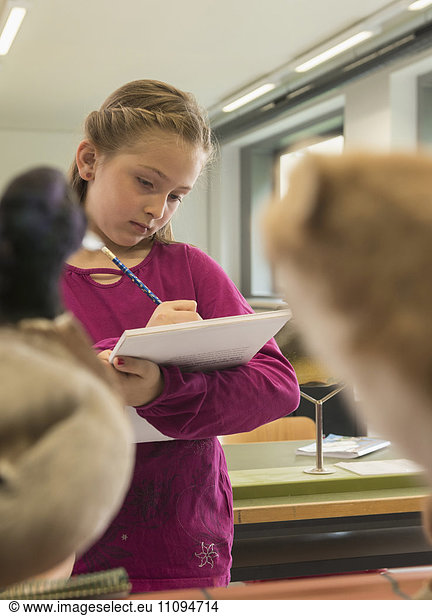 Girl making an animal sketch on her sketch pad in biology class  Fürstenfeldbruck  Bavaria  Germany