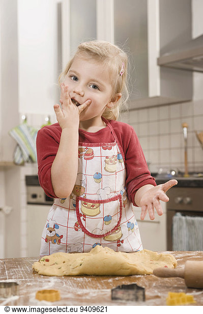 Girl nibbling dough  portrait