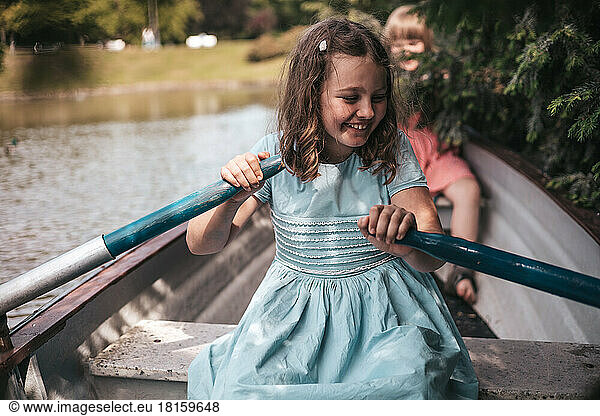 girl on a boat rowing oars  life in the village