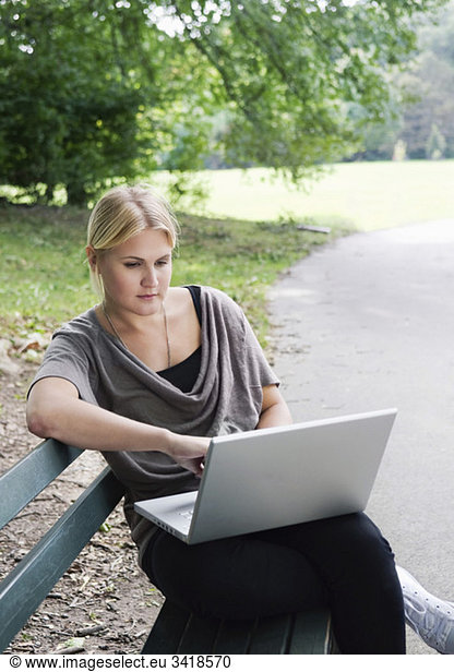 Girl on bench with computer