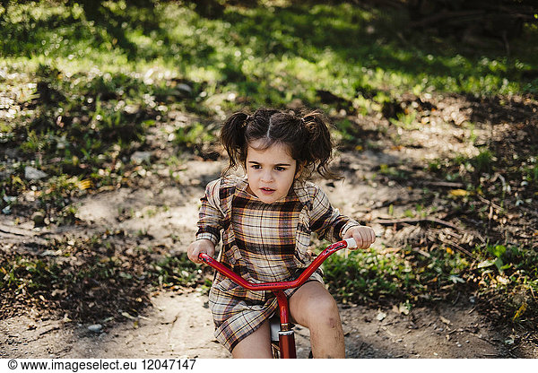 Girl on tricycle