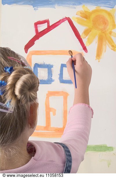 Girl painting a house