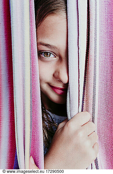 Girl peeking through hammock