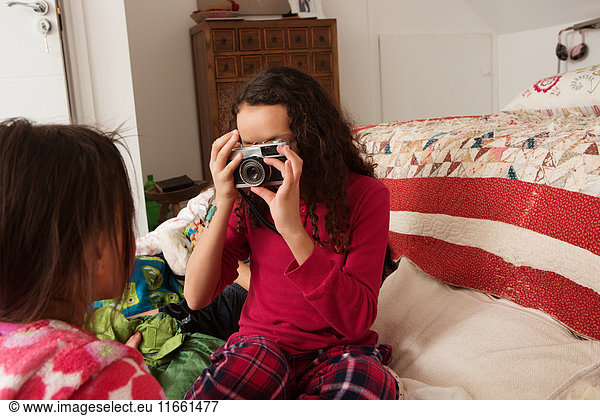 Girl photographing friend