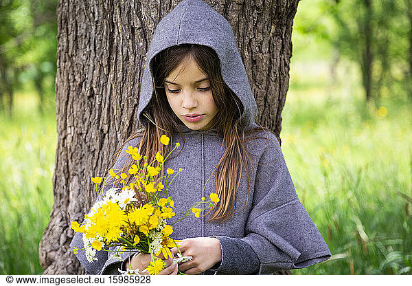 Girl picking yellow wildflowers