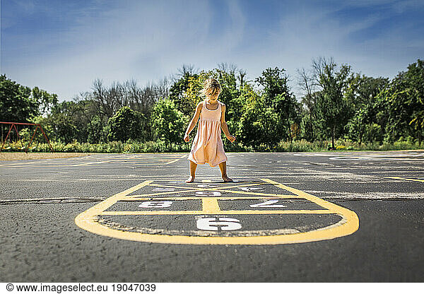 Girl playing hopscotch