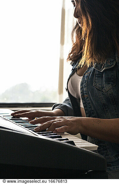 Girl playing piano during quarentine
