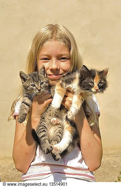 Girl playing with kittens