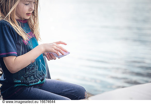 Girl Playing with Paper Boat By The Sava River in Belgrade  Serbia