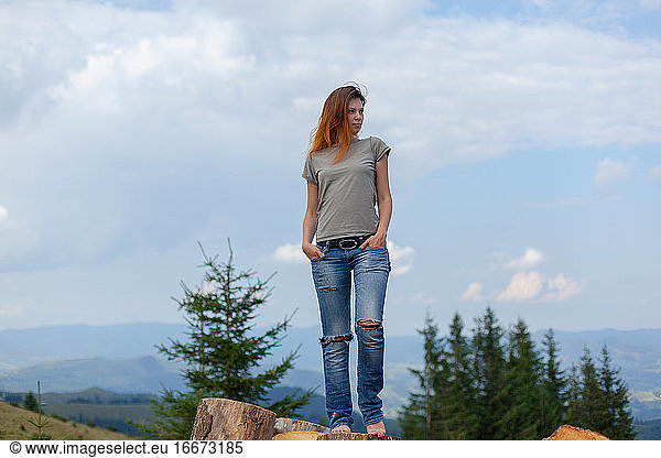 girl posing and gesturing in the summer high in the carpathian mountains