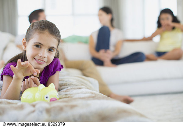 Girl putting coins in piggy bank