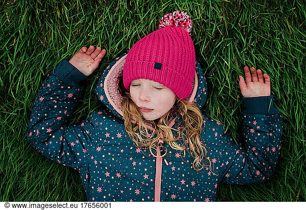 girl relaxing in the grass outside in the fresh air