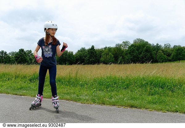 Girl rollerblading in park