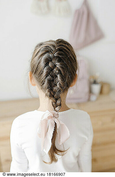 Girl showing french braid at home