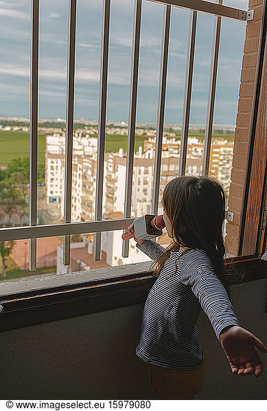 Girl singing at open window