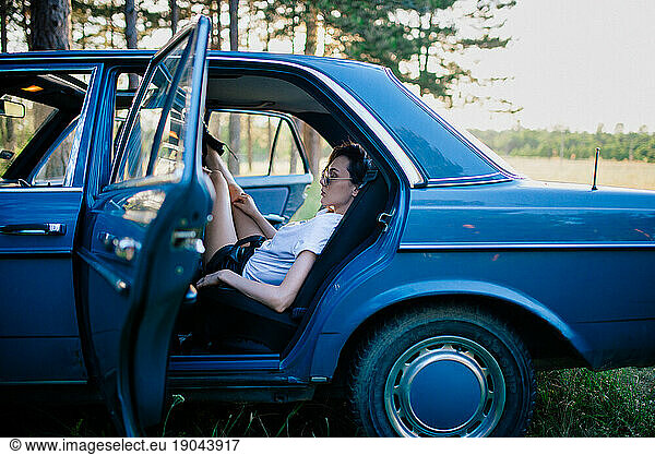 Girl Sitting In The Backseat Of An Old Car