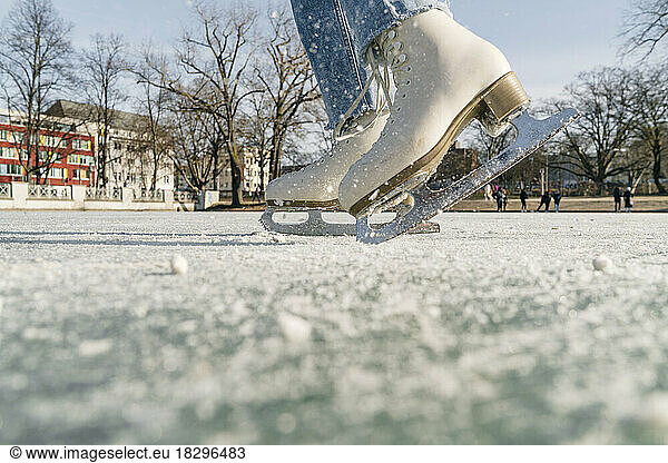 Girl skating on ice rink in winter
