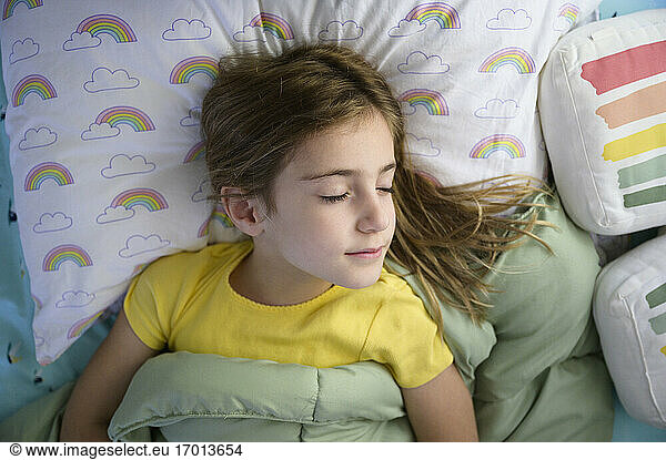 Girl (6-7) sleeping in bed