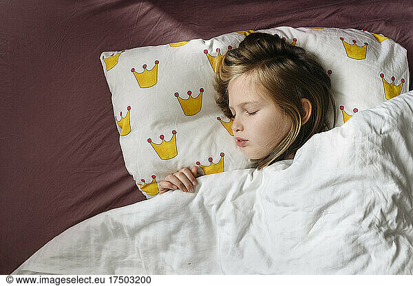 Girl sleeping in bed at home