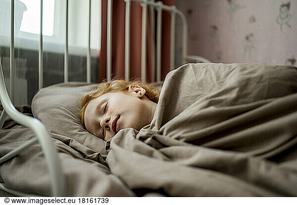 Girl sleeping in bed at home