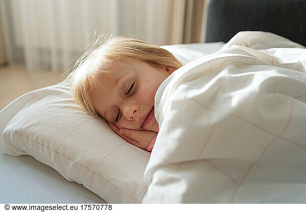 girl sleeping in the bedroom on a sunny morning