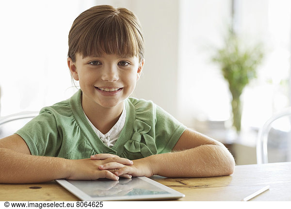Girl smiling with tablet computer