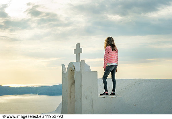 Girl standing on top of church  Oía  Santorini  Kikladhes  Greece