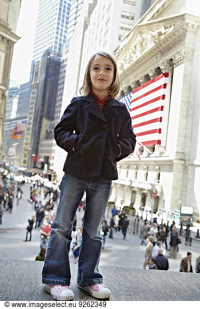 Girl standing outside New York Stock Exchange  New York City  New York  United States