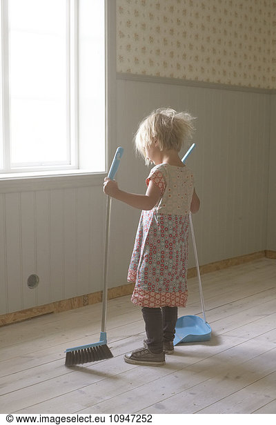 Girl sweeping floor