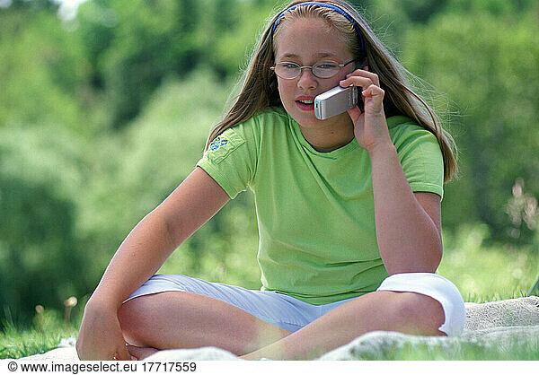 Girl Talking On Cell Phone Outdoors