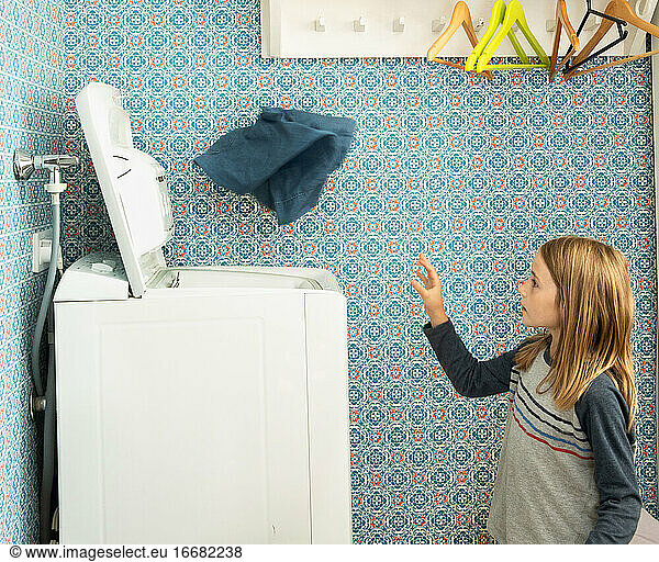 Girl Throwing Laundry Into Washing Machine in Helsinki  Finland