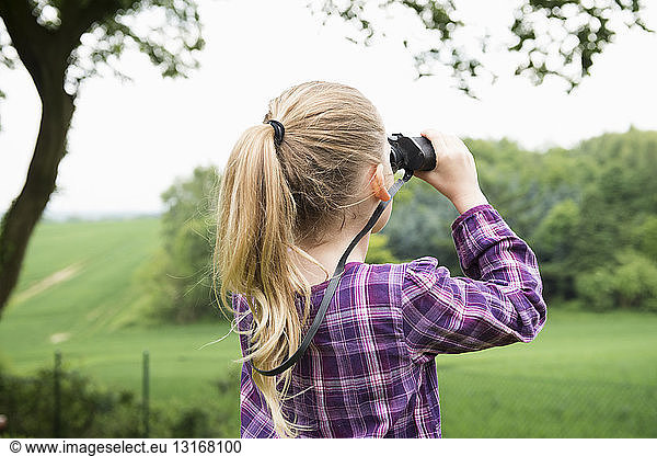 Girl using binoculars