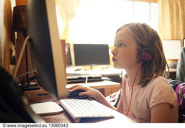 Girl using desktop computer at computer lab